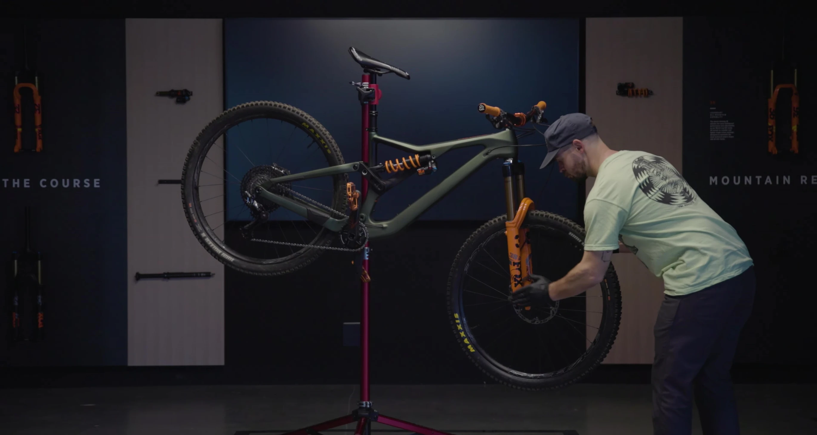 Mechanic removing the front wheel of a bike for easier access.