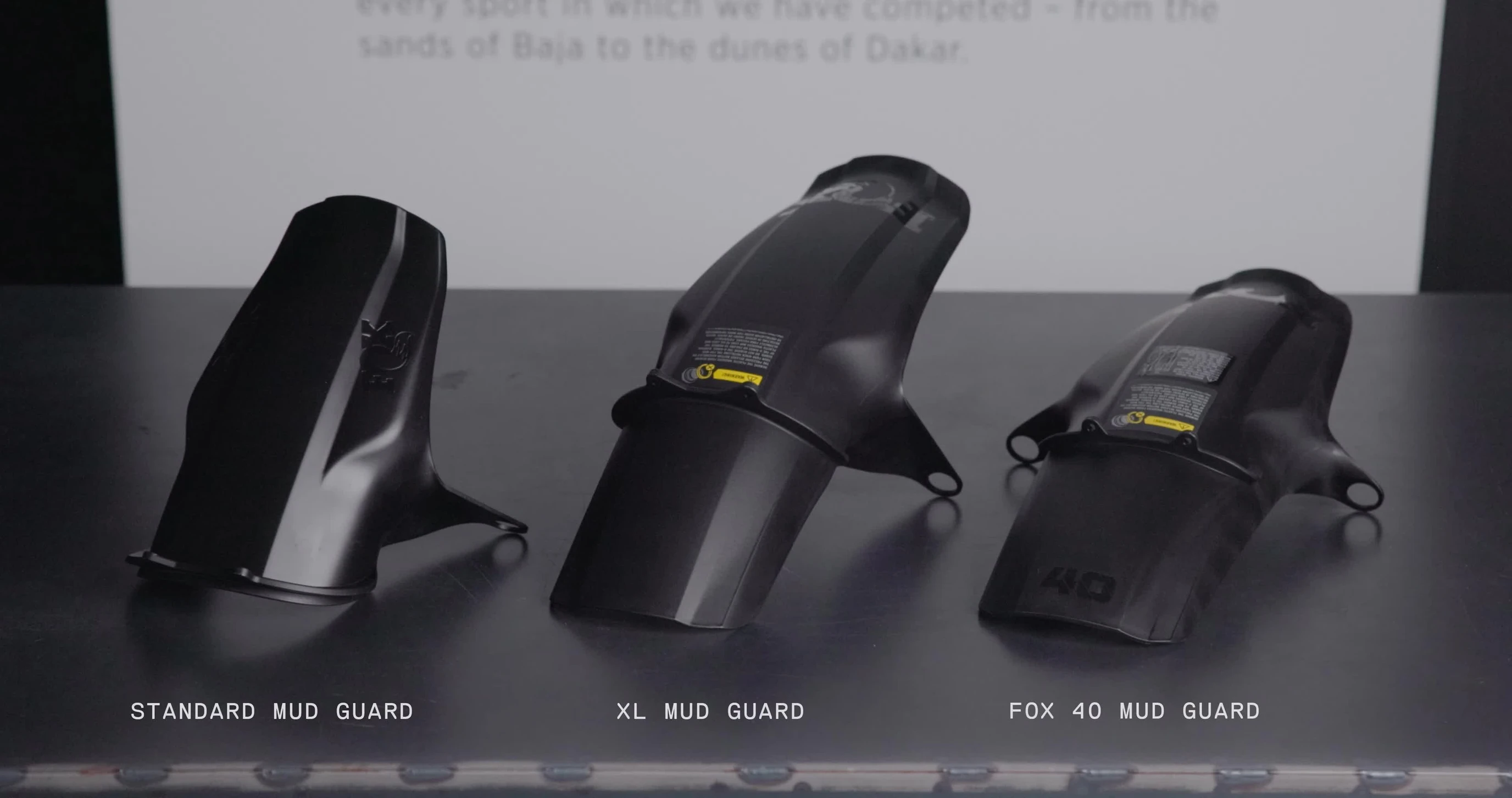 Close-up of different FOX mudguard models highlighting their compatibility differences.