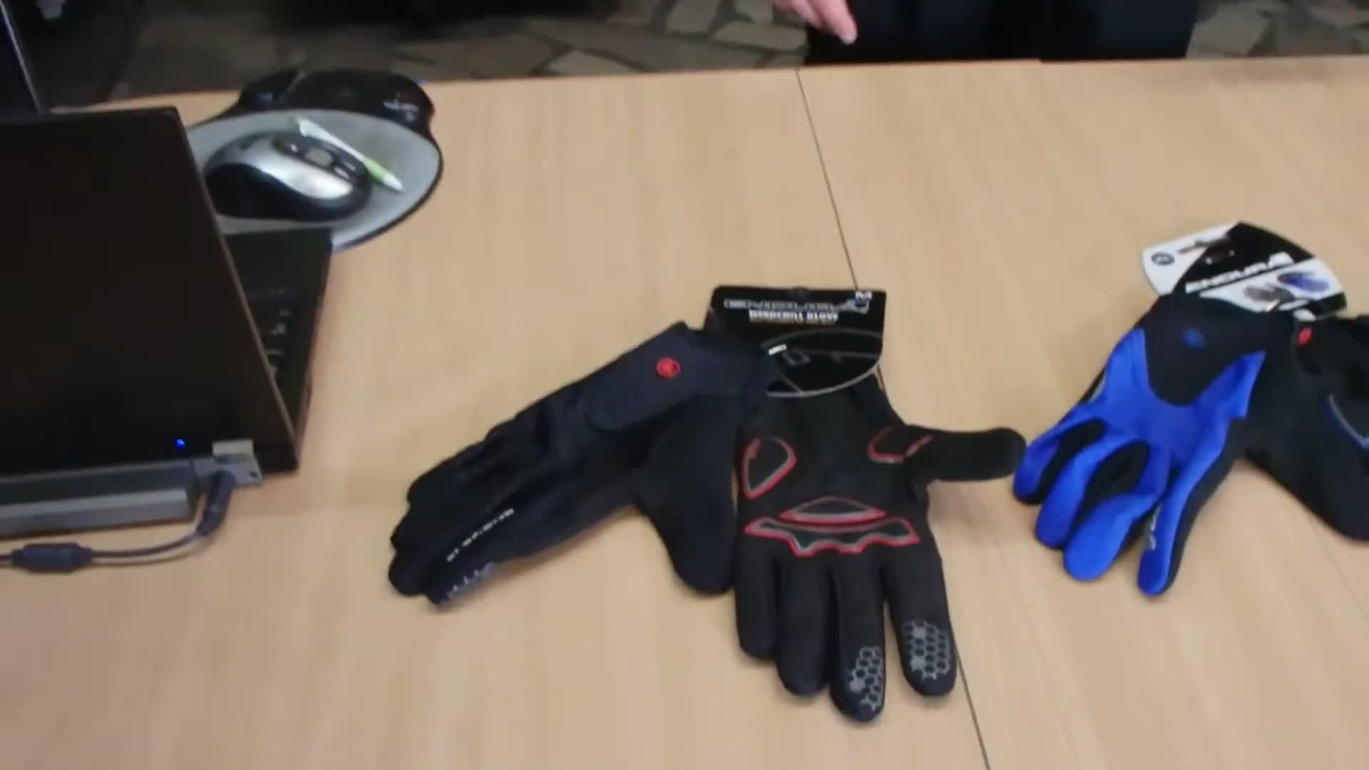 Close-up of the Endura Windchill gloves in black, blue, and red.