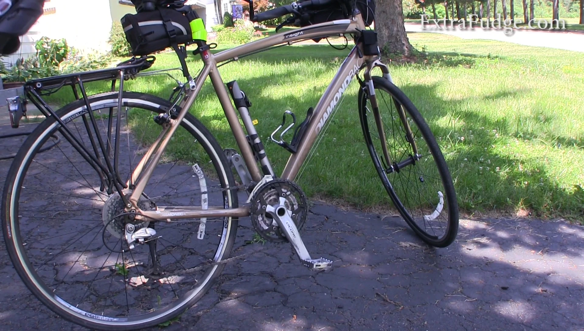 The reviewer demonstrating how to attach the pump to the bike frame.