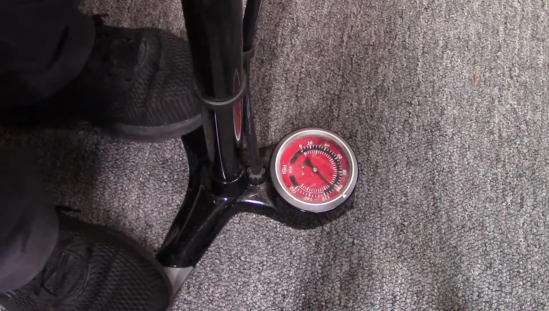 Close-up of a bicycle valve being tapped