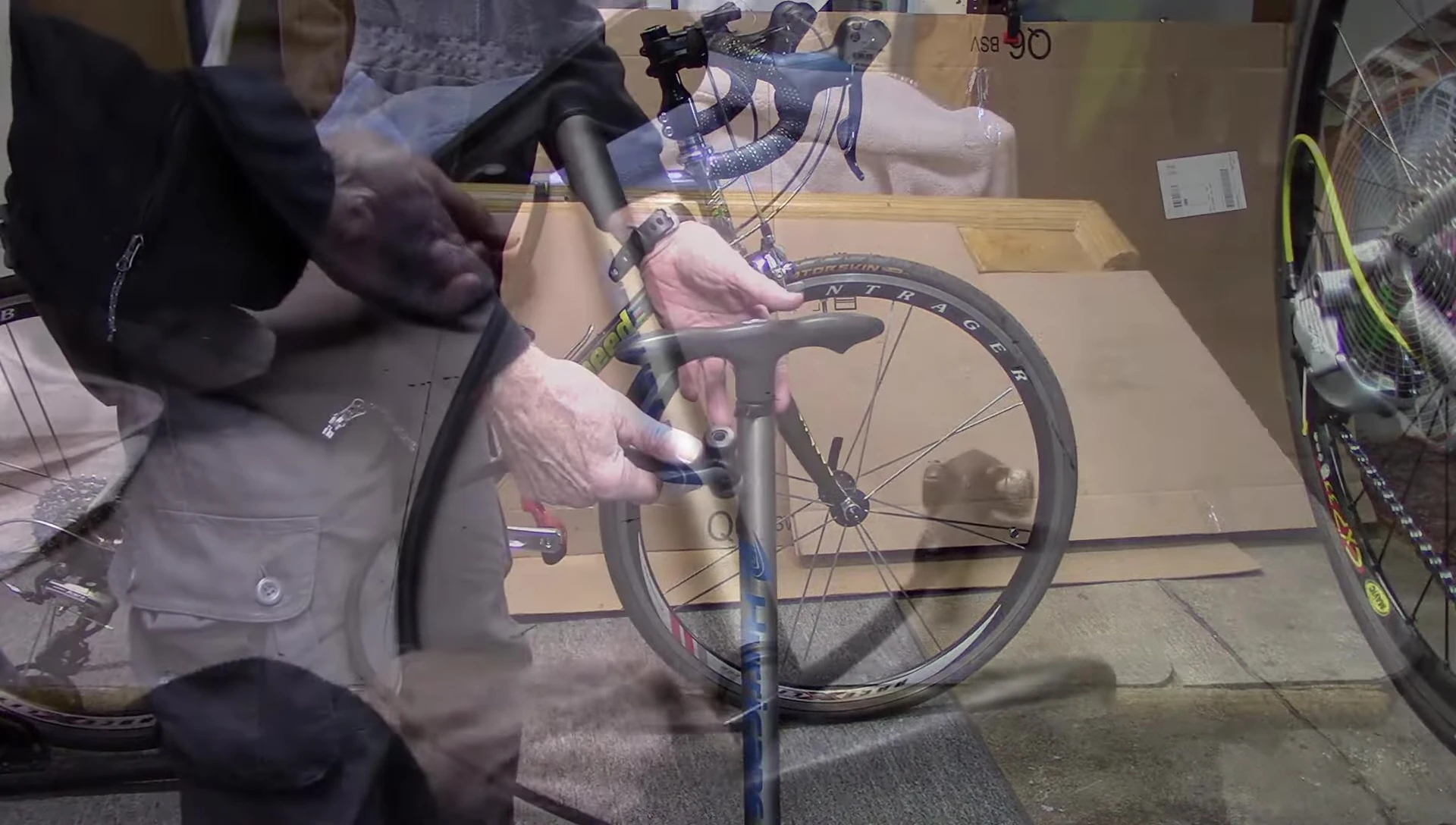Close-up of bicycle pump tubing and chuck being inspected.