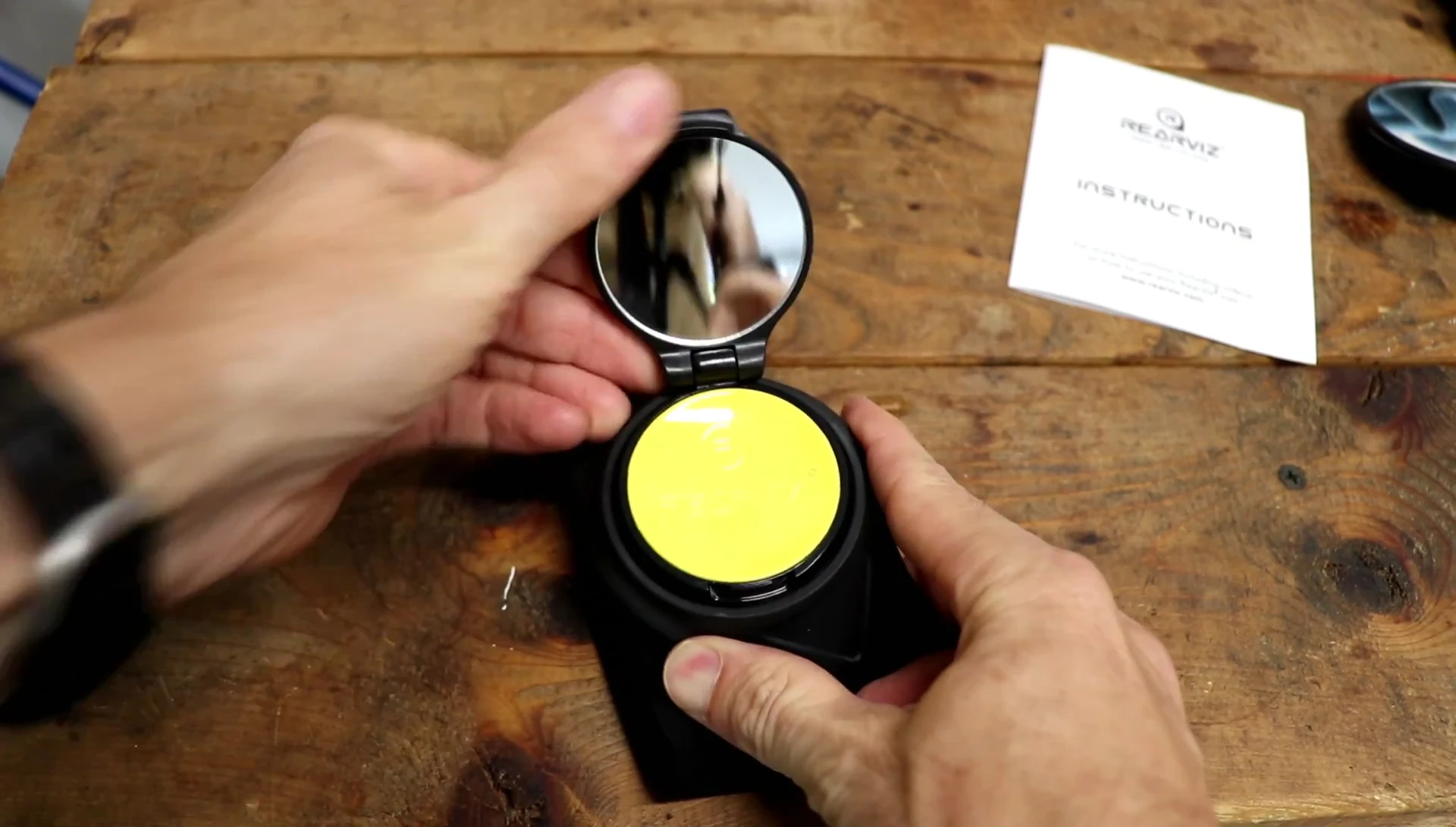Demonstrating the mirror's flip-up and swivel function
