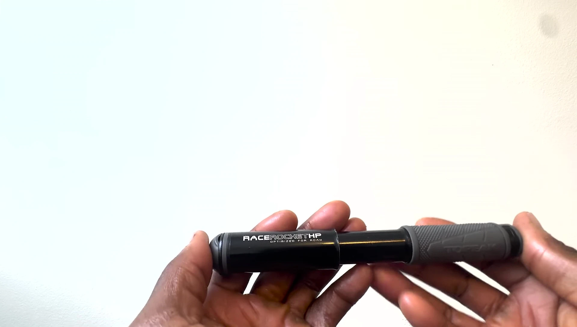 Close-up shot of the pump in the reviewer's hand, emphasizing its small size.