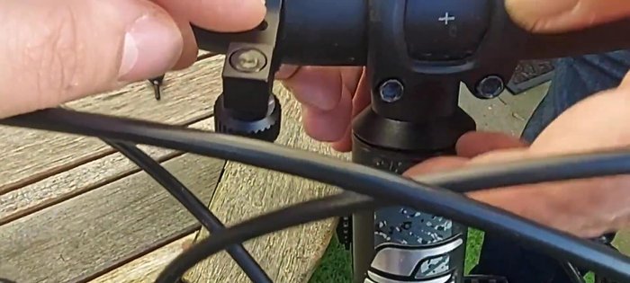 Position the mount with the clamping mechanism facing forward. Ensure the threaded part is at the top.