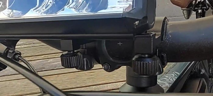 Once the alignment is satisfactory, firmly tighten the clamps to secure the headlight.