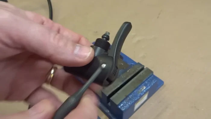 Pull off the lever and push out the internal parts (plastic parts, ball, gaskets) using a punch.