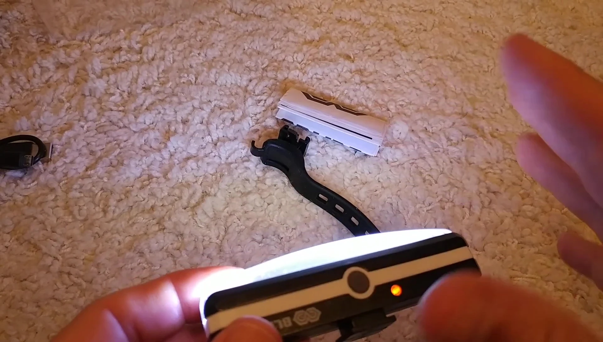 The reviewer demonstrates the flashing modes of the bike light.