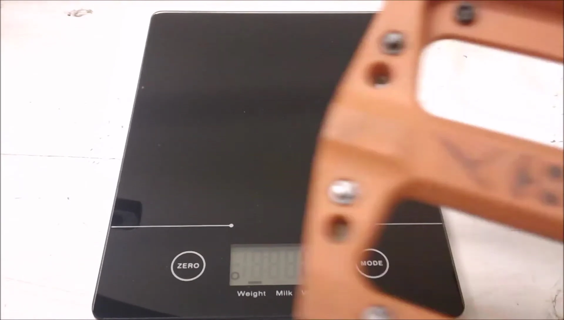 Close-up of the digital scale measuring a pedal's weight
