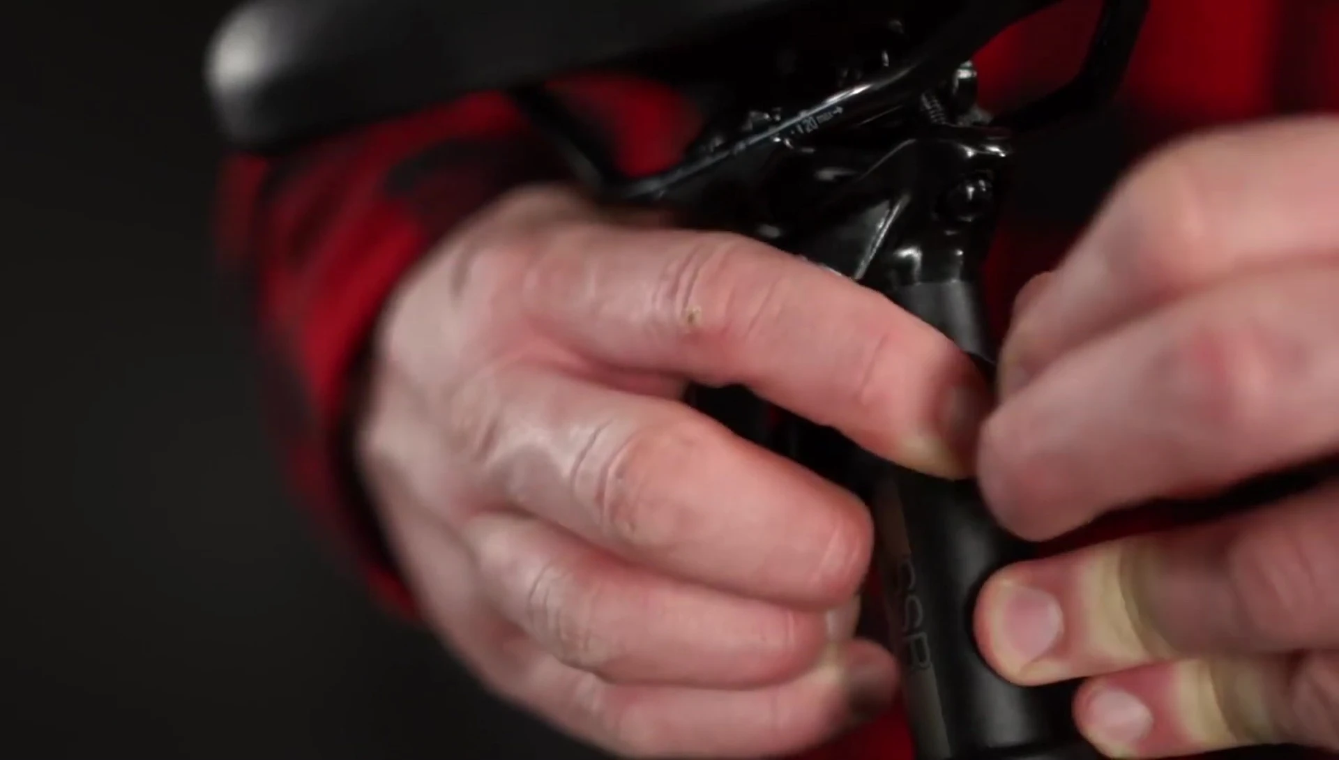 Demonstrating how to attach the rear light bracket to the seatpost.