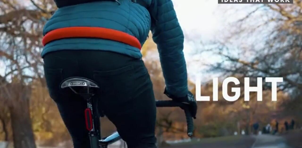 LITELOK CORE lock being demonstrated, highlighting its lightweight and compact design
