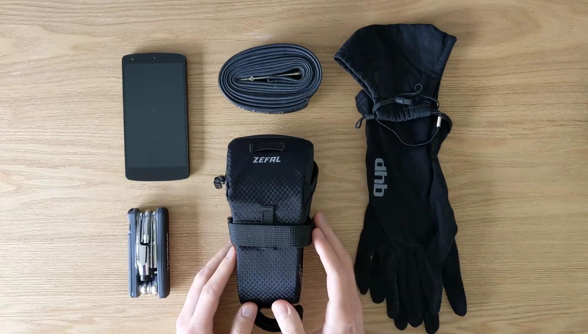 The reviewer demonstrating how easily the bag can be attached and secured.