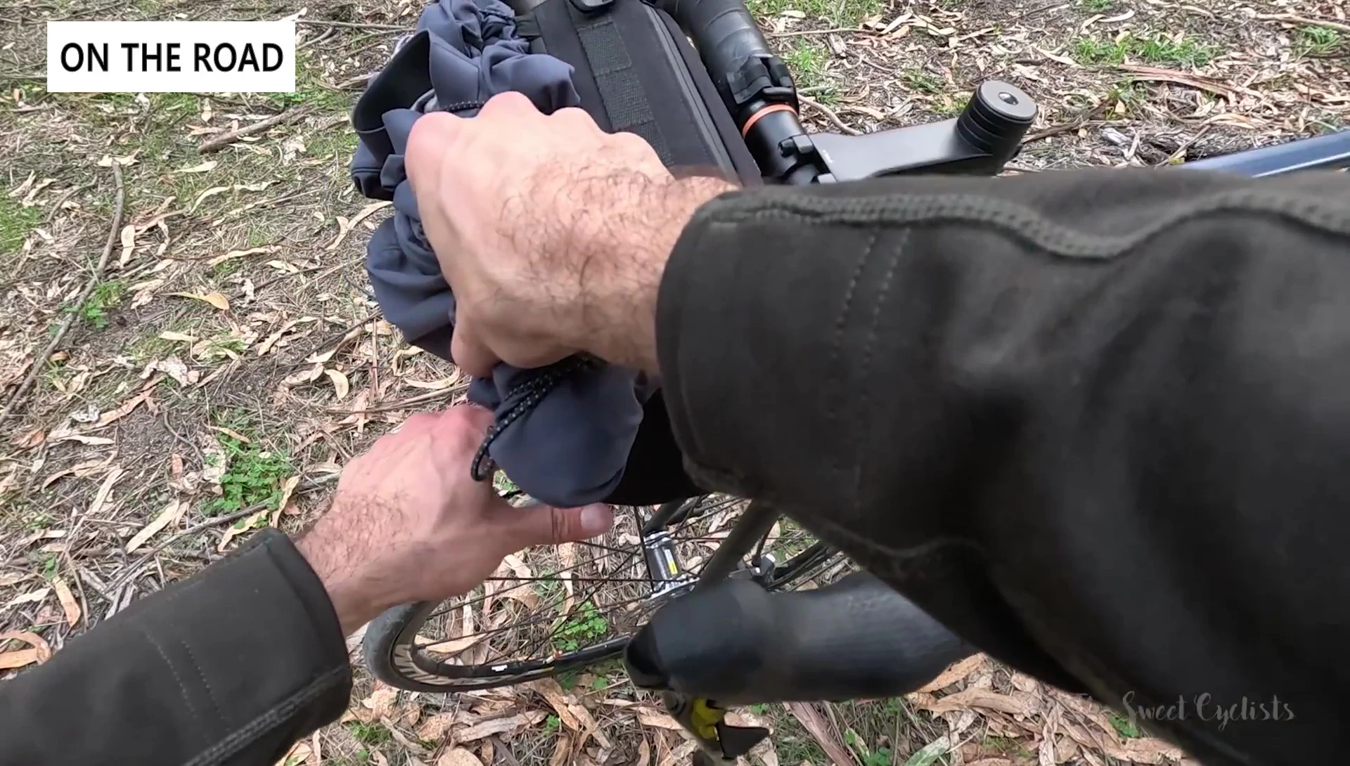The bag mounted on the bike, demonstrating the functionality of the bungee cords.