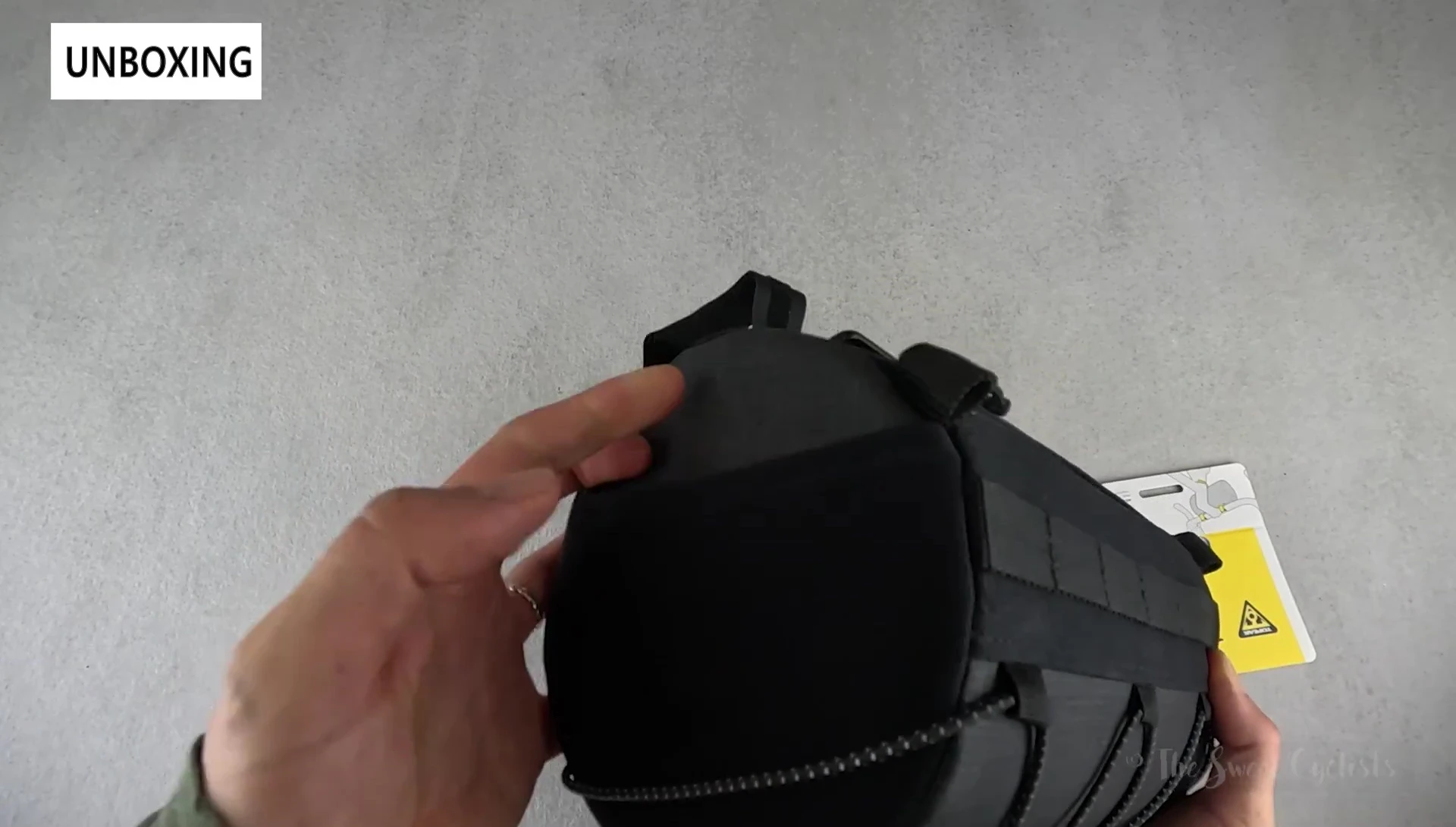 View of the bag's three-pocket design, illustrating the main compartment and side mesh pockets.