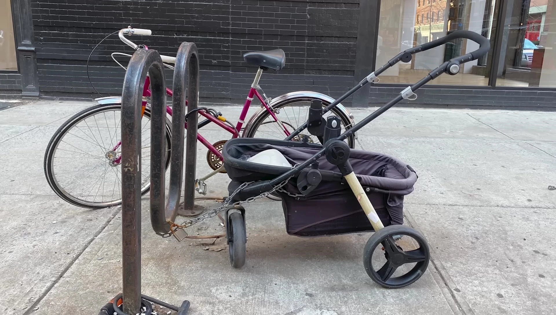 A close-up of a damaged bike, showing missing wheels and other components.