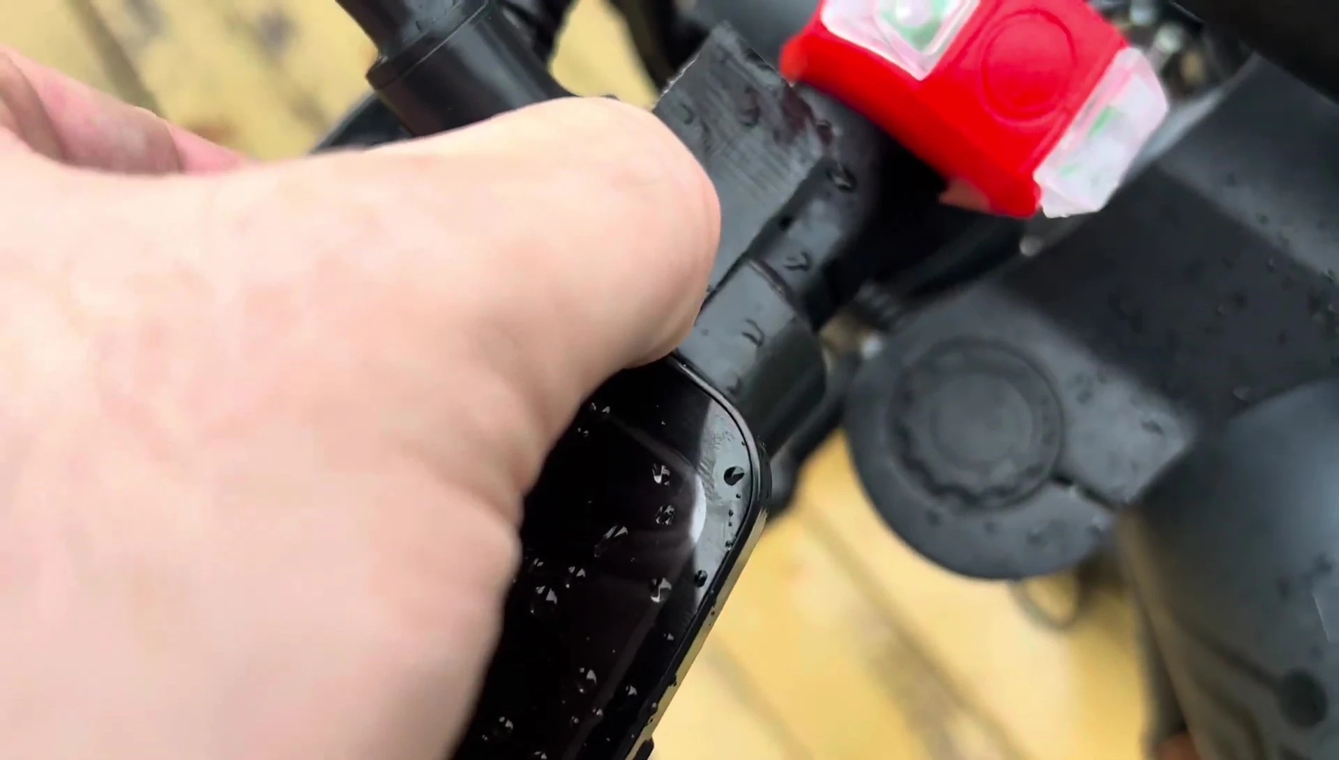 The reviewer applying electrical tape to secure the base.