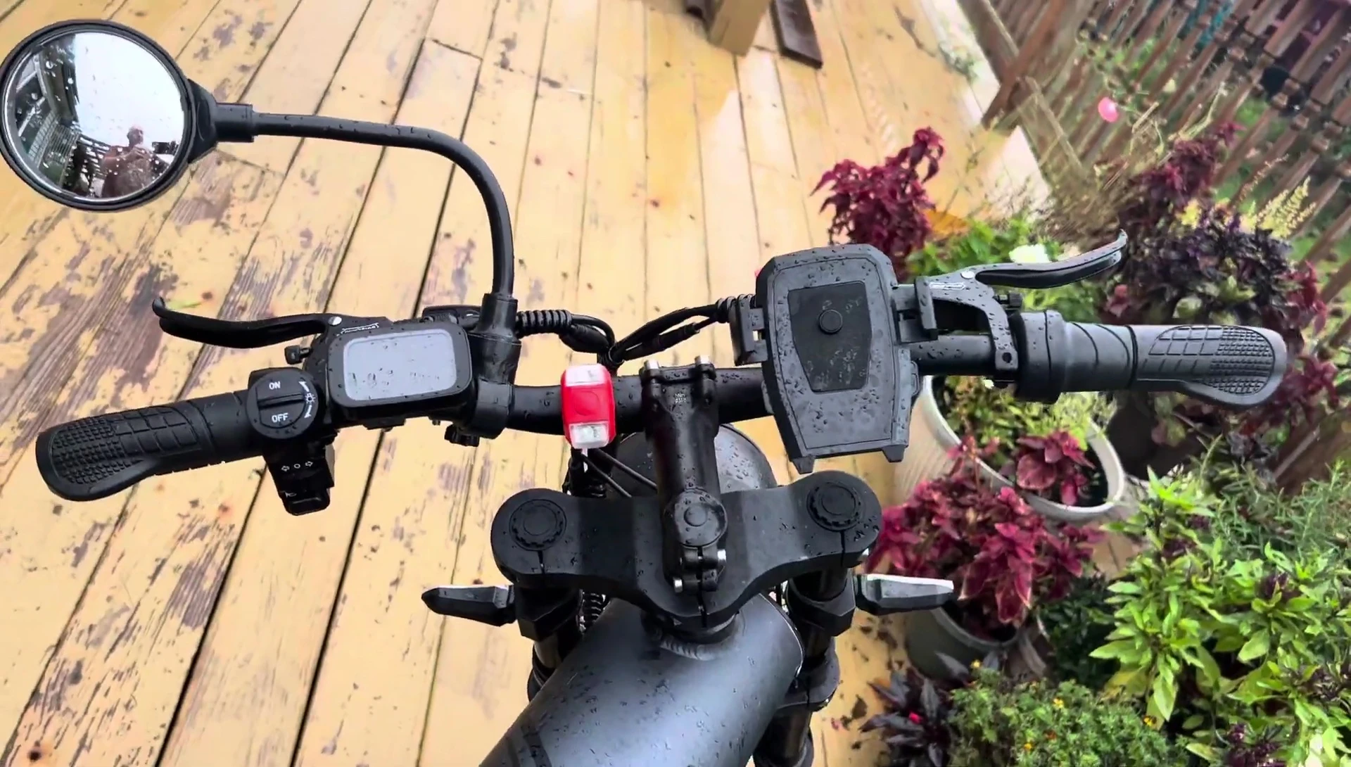 The mirror mounted on the bicycle, showing its position relative to the handlebars.