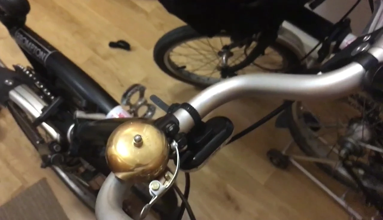 The Japanese crane bell shown on a bicycle tire for size comparison.