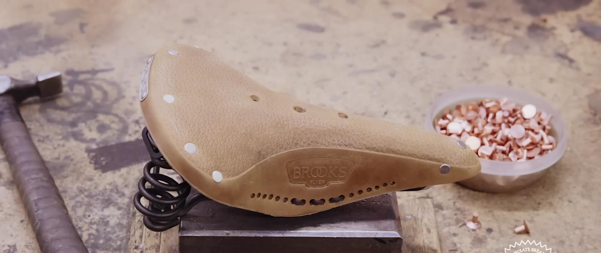 A Brooks Age line saddle, highlighting its pre-treated leather and laced skirt.