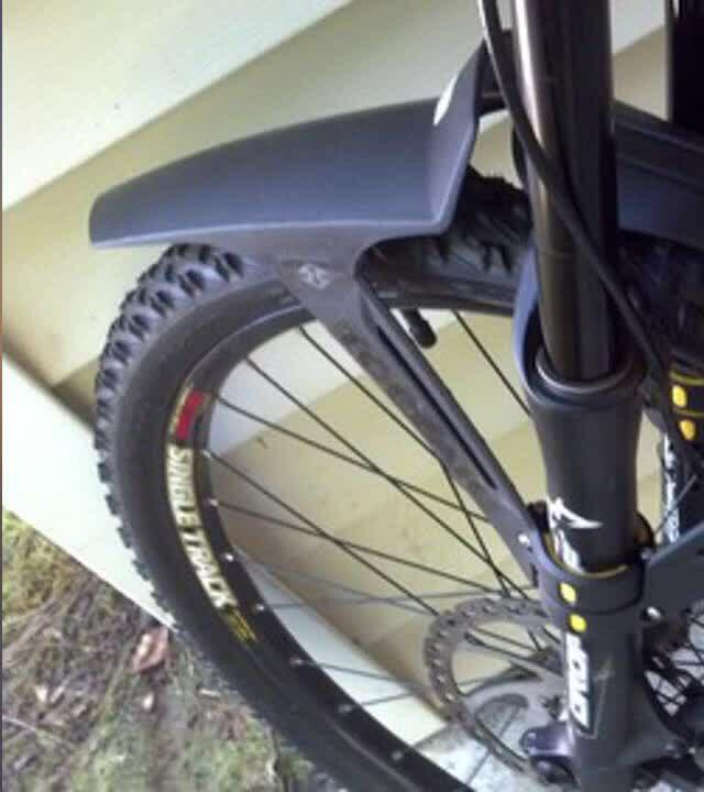 Close-up of the Topeak Defender XC1 installed on a bike fork, showing the duct tape solution.