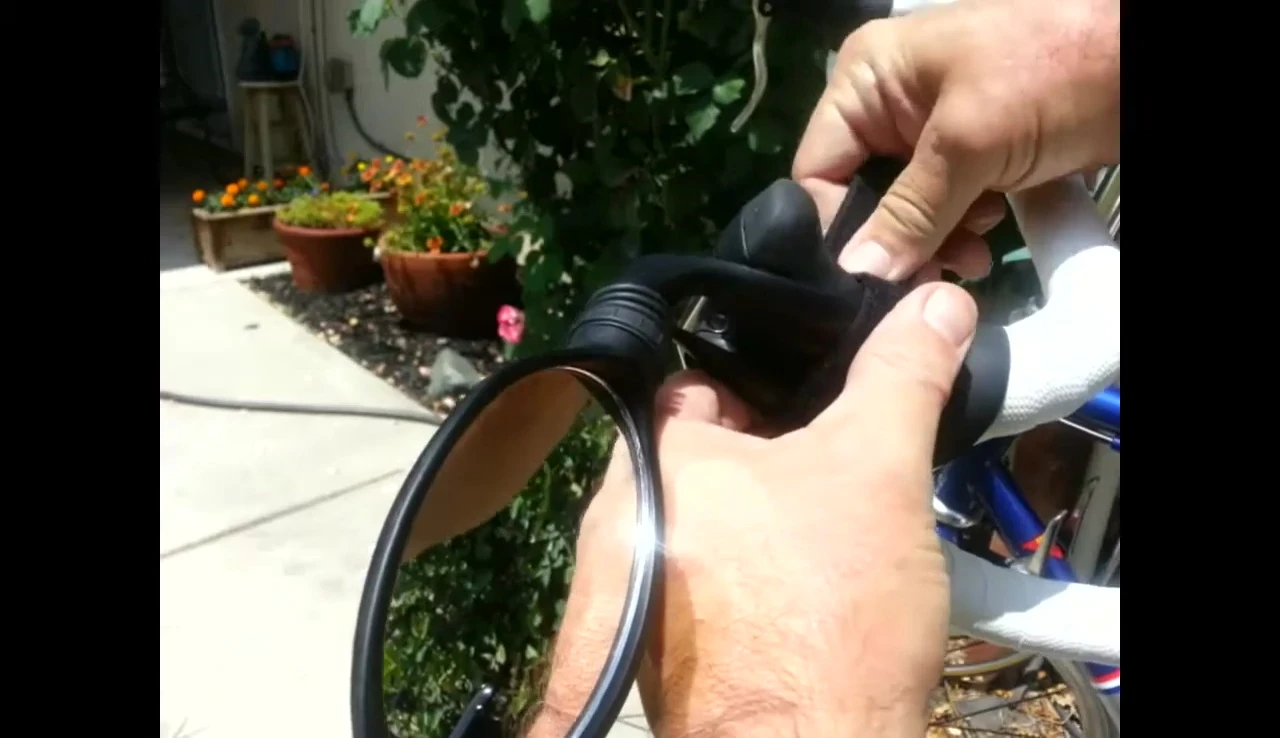 Securing the mirror with velcro strap.