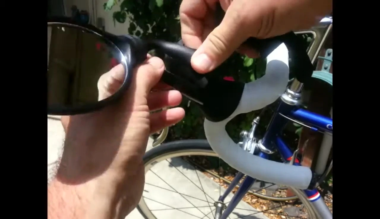 The mirror snapping onto the brake hood.