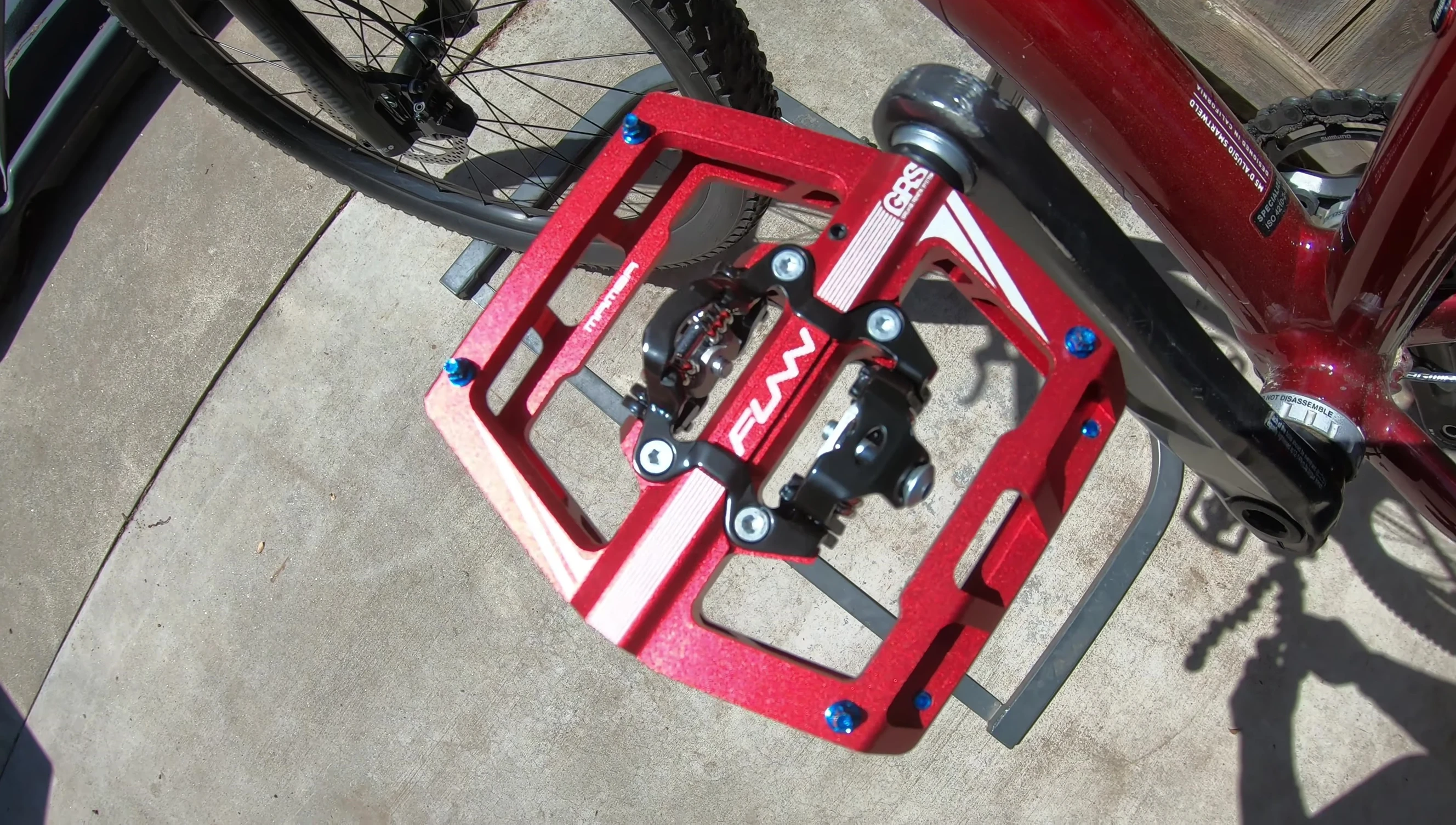 Rider's feet on the pedals, showcasing the platform's size and comfort.