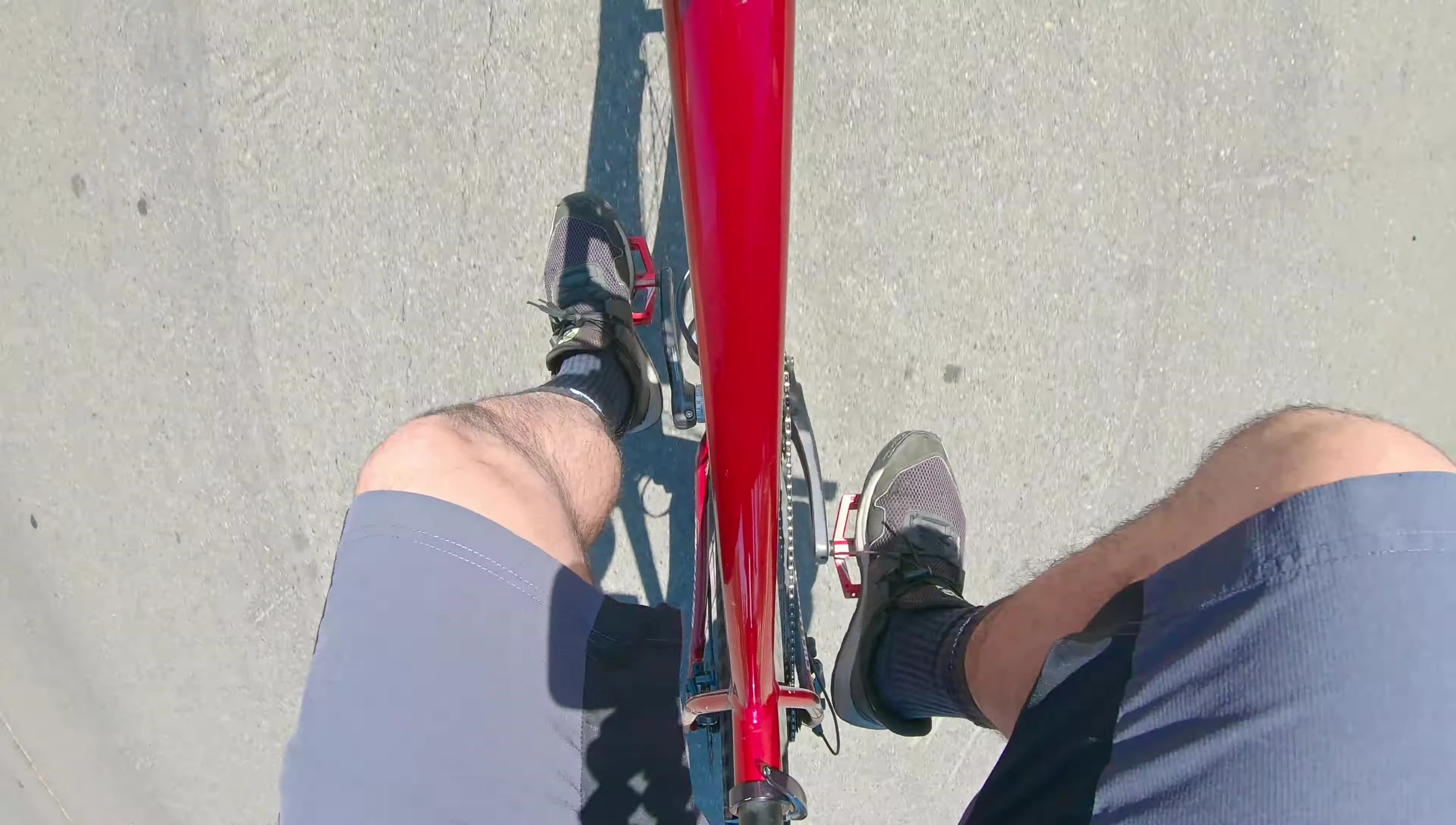 Close-up of the rider's foot on the pedal with regular shoes.