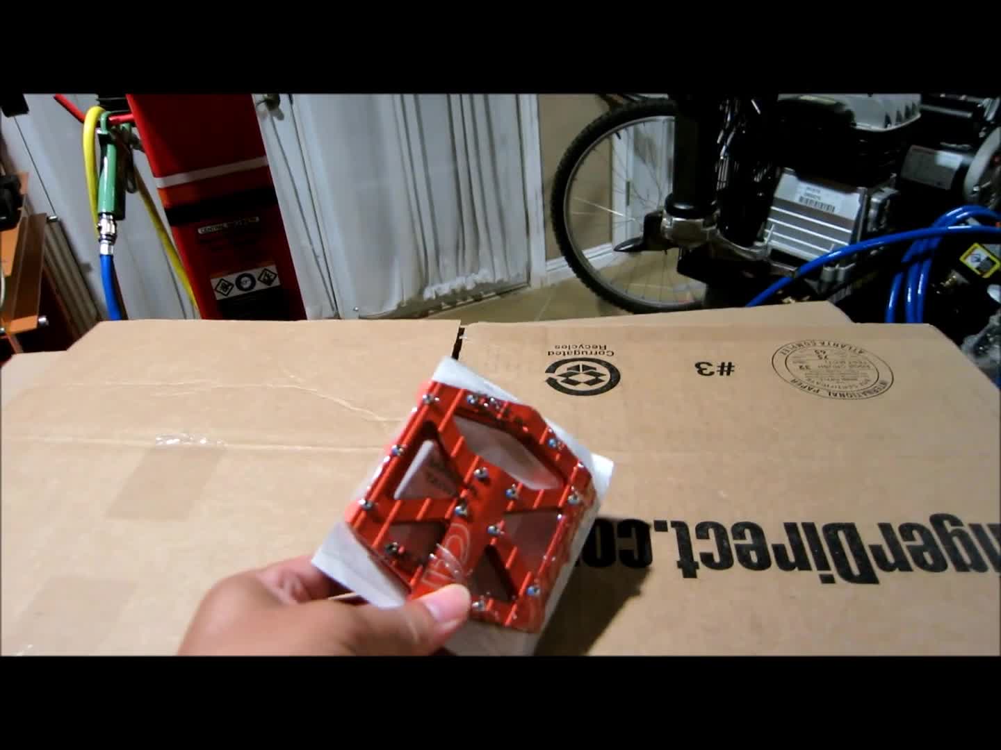 Close-up of the orange VP-001 pedals in the packaging.