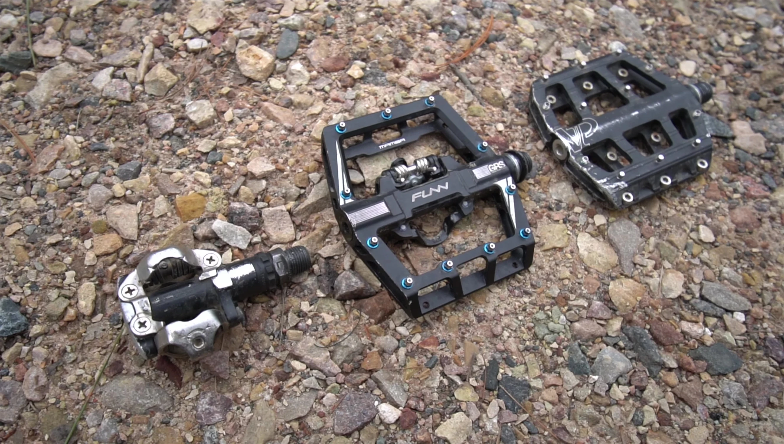 The narrator holding the Fun Mambas pedals, emphasizing the combined features.