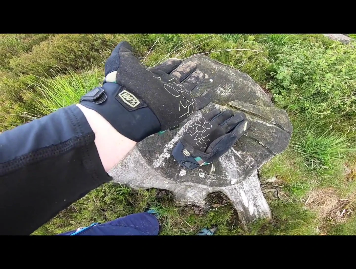 The speaker showing the neoprene cuff of the gloves.