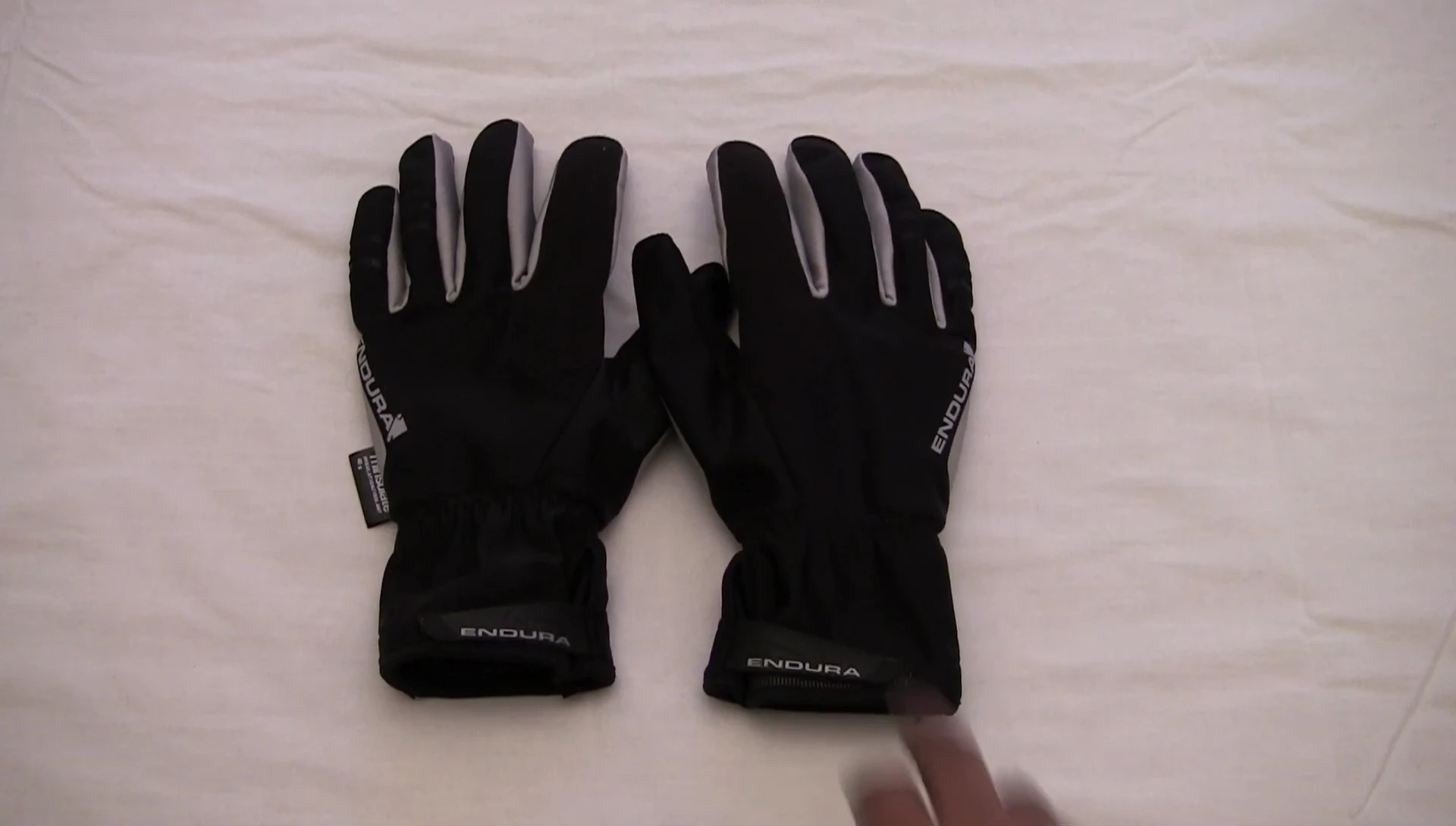 The reviewer demonstrating space for liners within the glove.