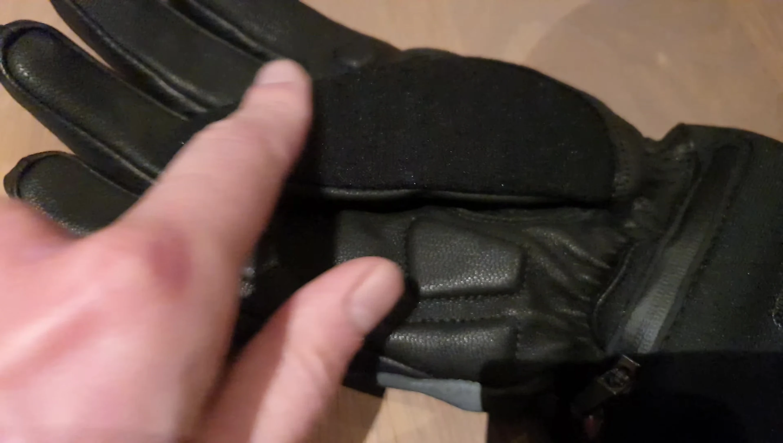 Hand using the glove to wipe something, demonstrating its practicality.