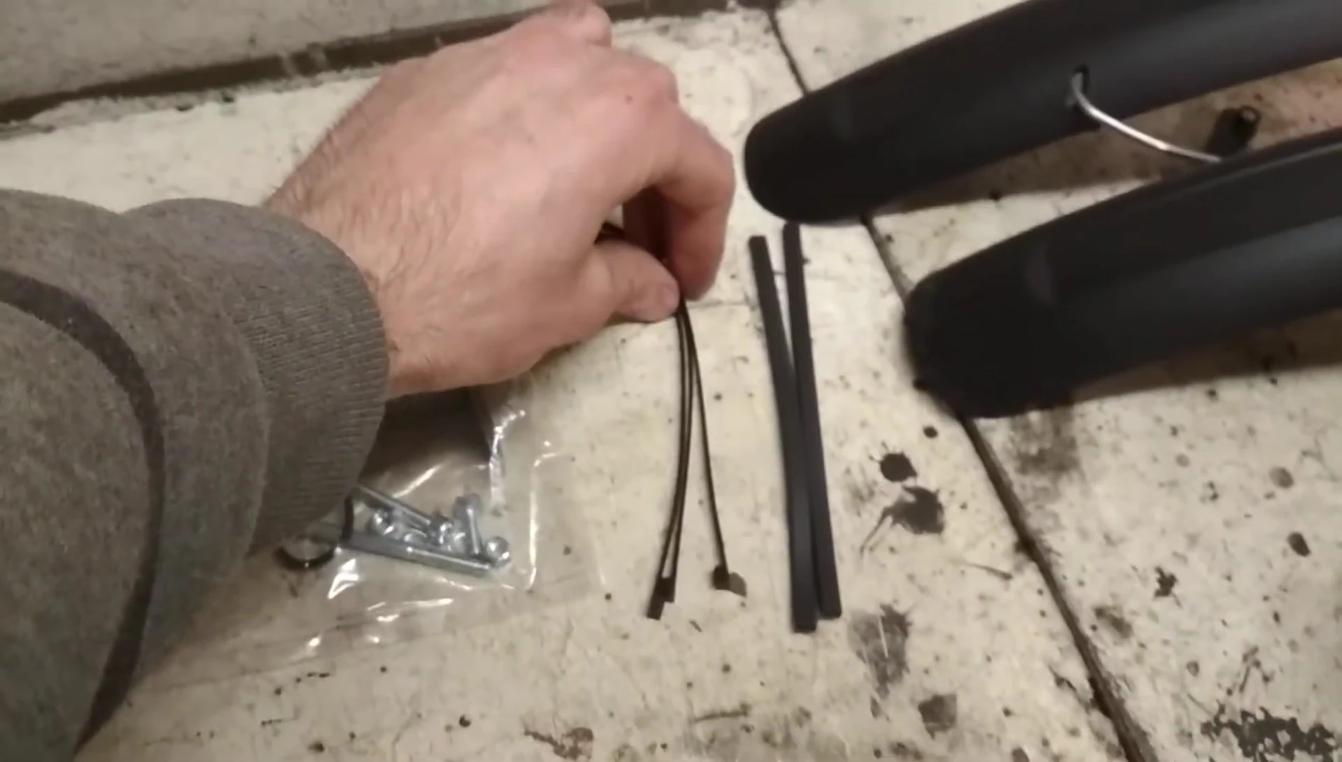 Close-up of the contents of the package, including zip ties and hardware.