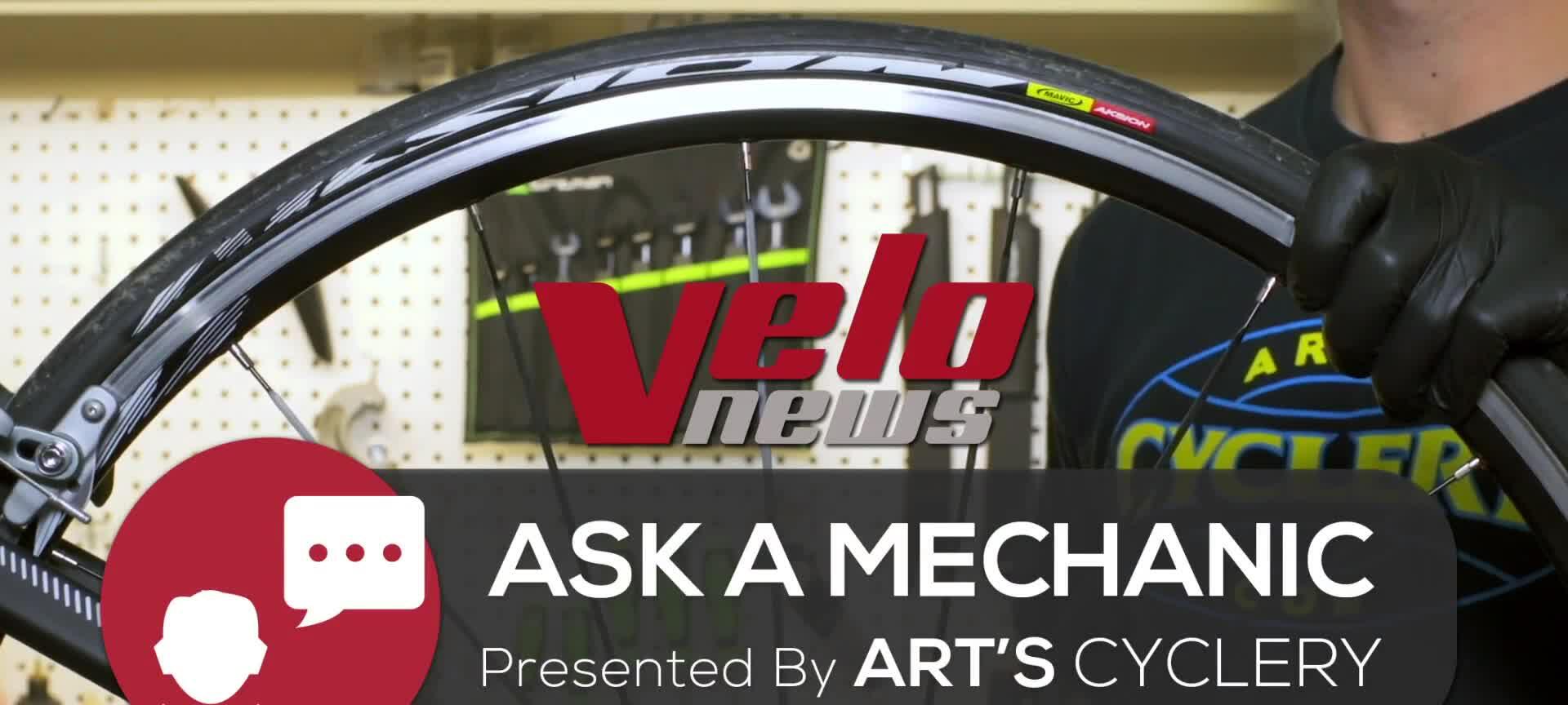 Visual of a cyclist inflating a tire, highlighting the pump head connection.