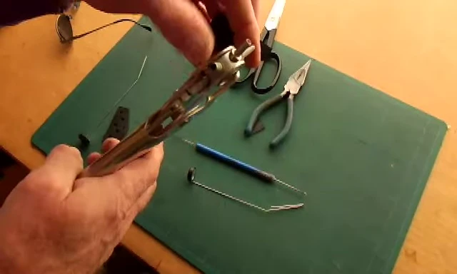 Using a hole punch to create holes in the rubber piece.