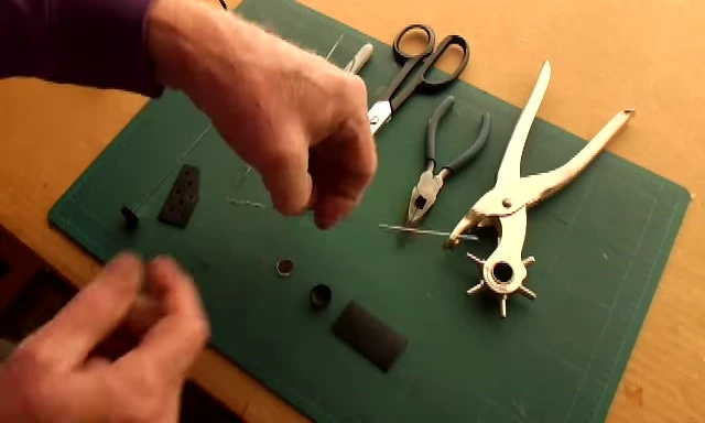 Bending the wire arm to create the frame of the mirror.