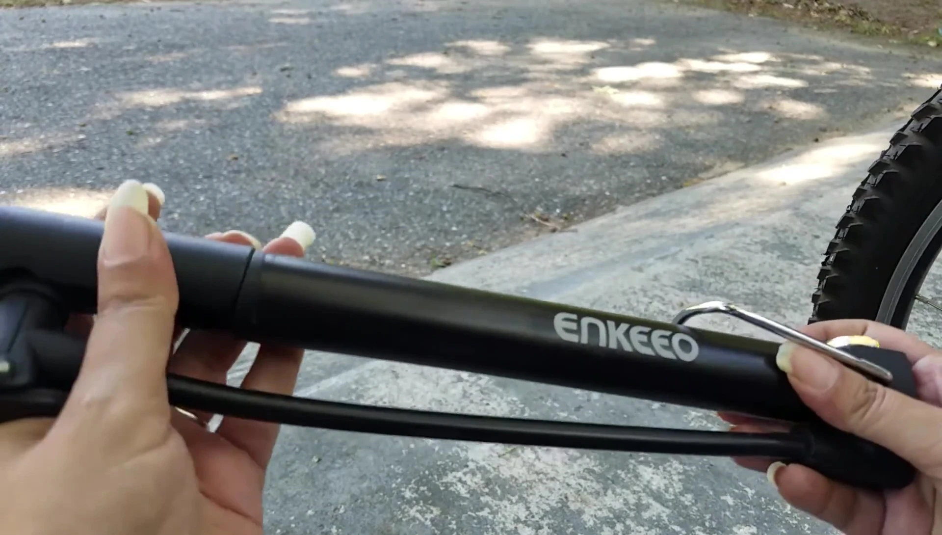 The handle of the Enkeeo mini pump neatly folded for compact storage.