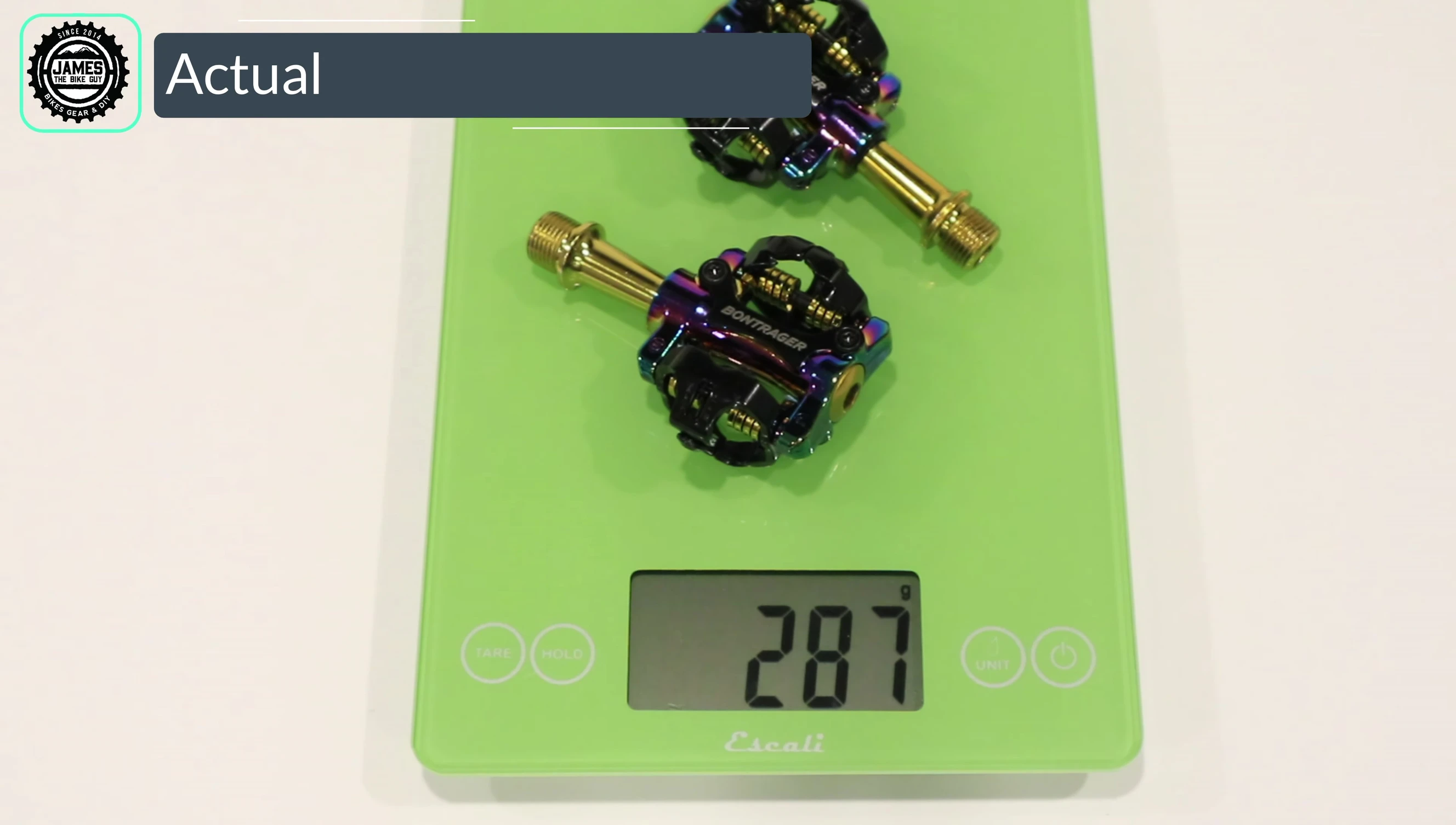 The pedals on a scale displaying their weight.
