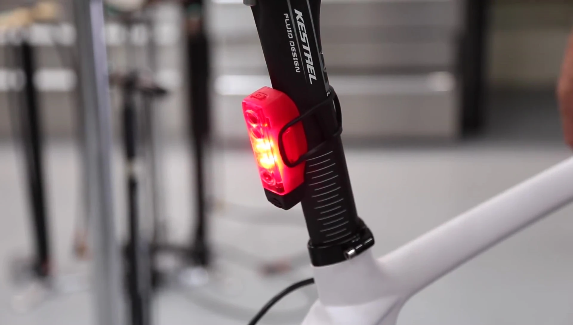 The Strip Drive mounted on a bicycle, showcasing its adaptability to different frame shapes.