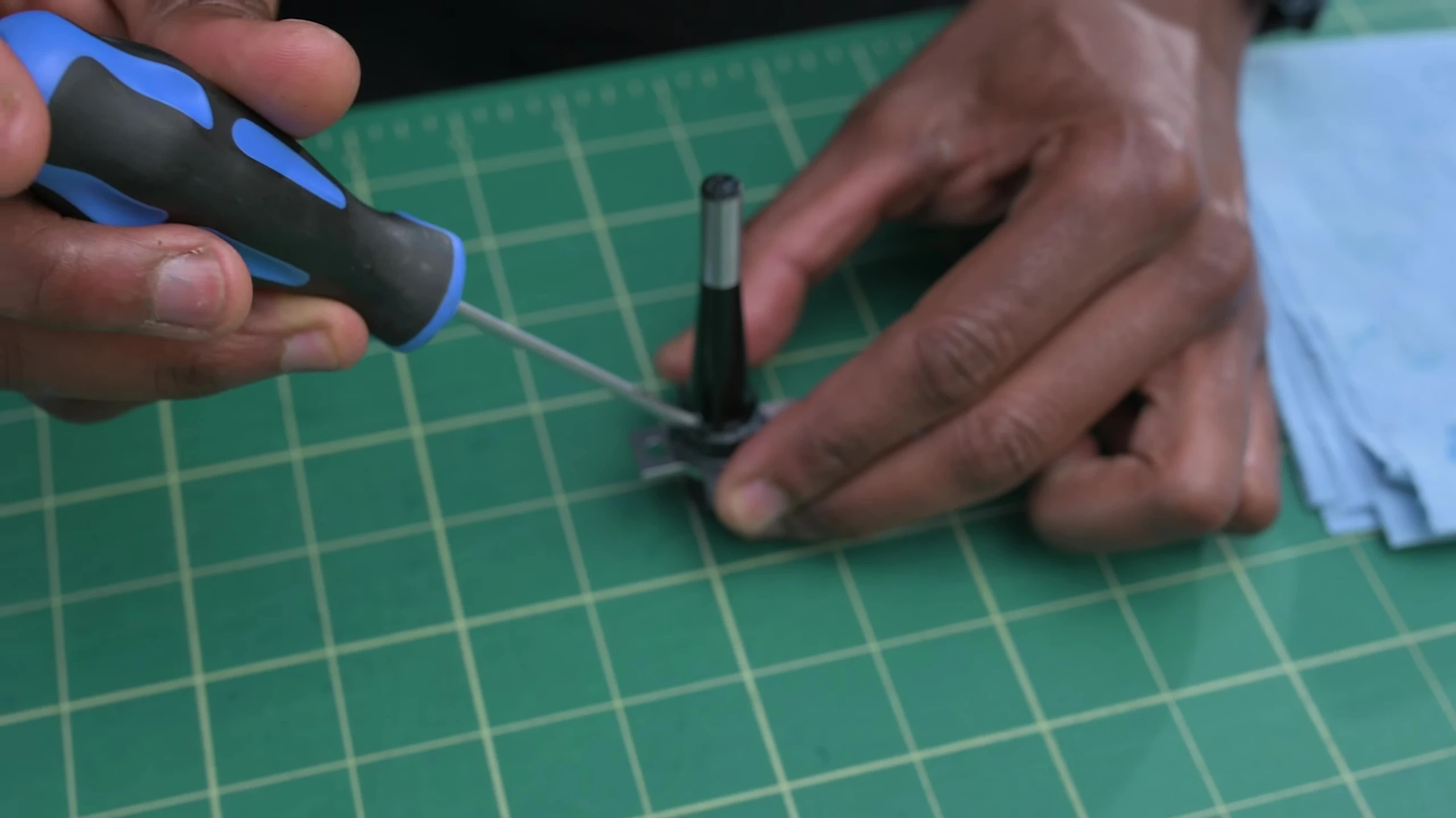Using a small flathead screwdriver to remove the inner bearing halves.