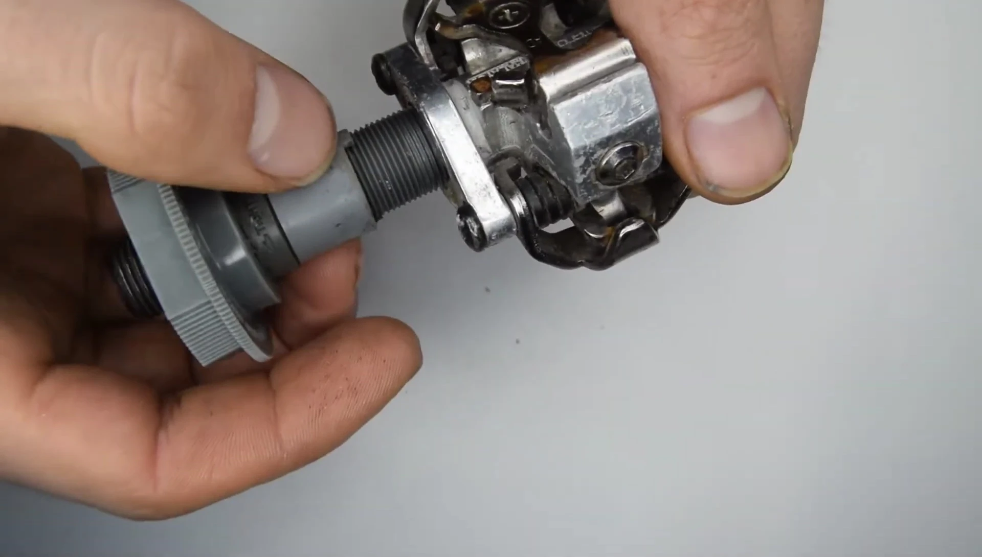 The plastic bushing with teeth, characteristic of some SPD models.
