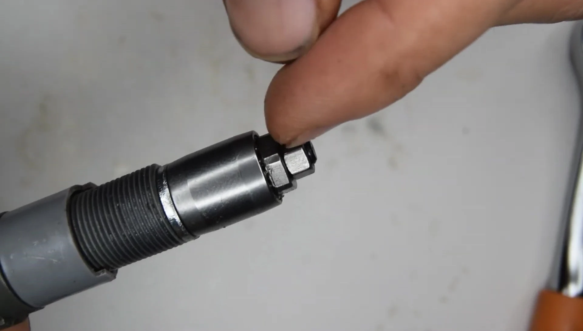Tightening the cone nuts and lock nut simultaneously using two wrenches.