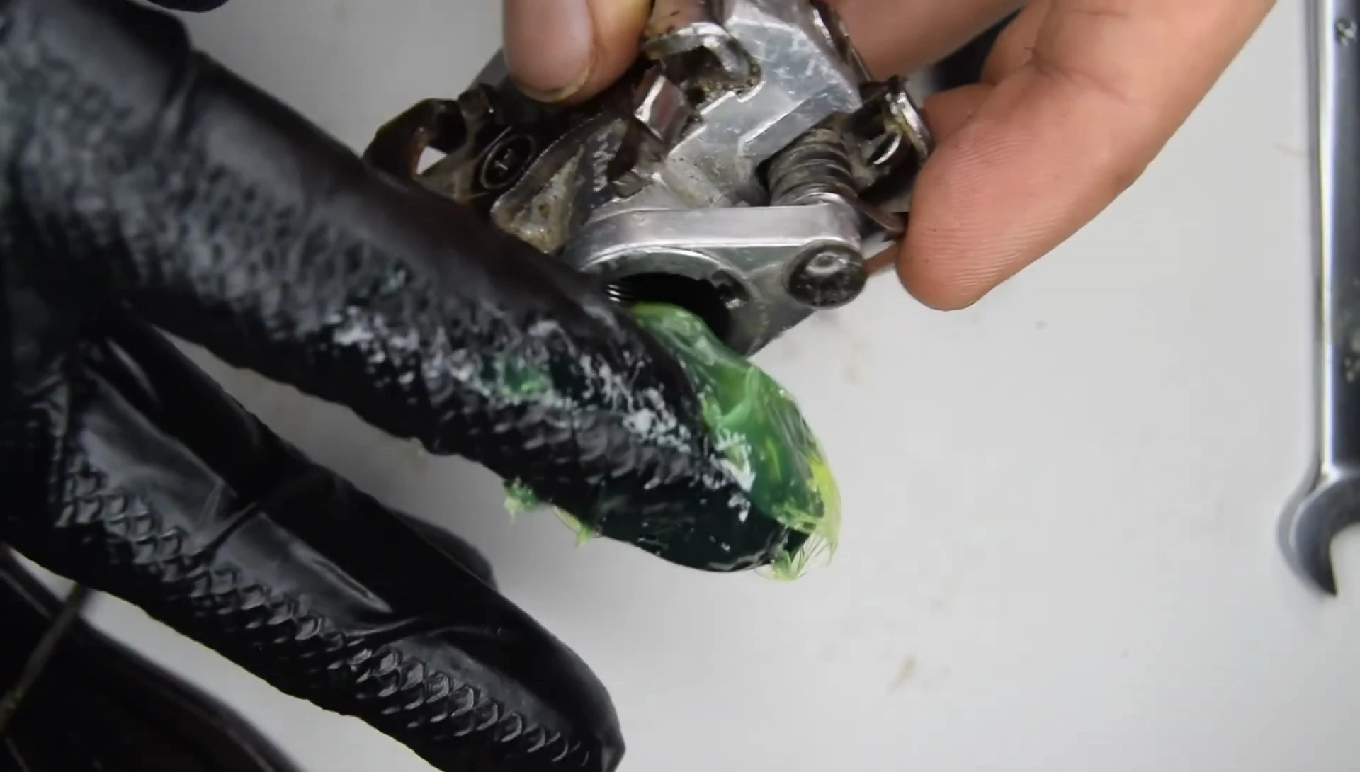 Applying grease to the pedal axle before installation.
