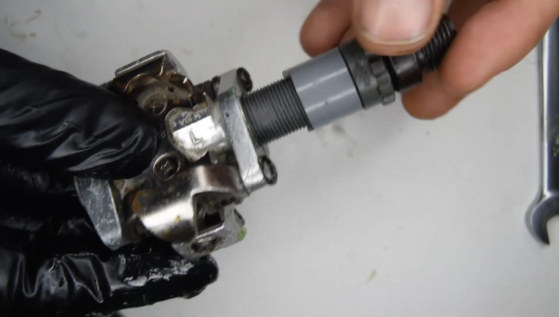 Tightening the pedal axle to ensure a secure and smooth rotation.
