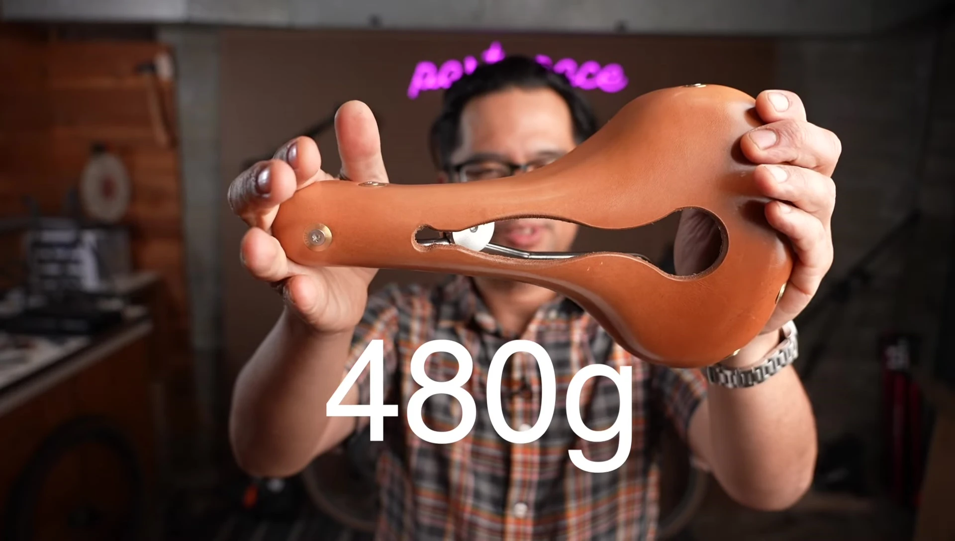 Close-up shot of weight measurements for Brooks B17 and Berthoud Aspen saddles.